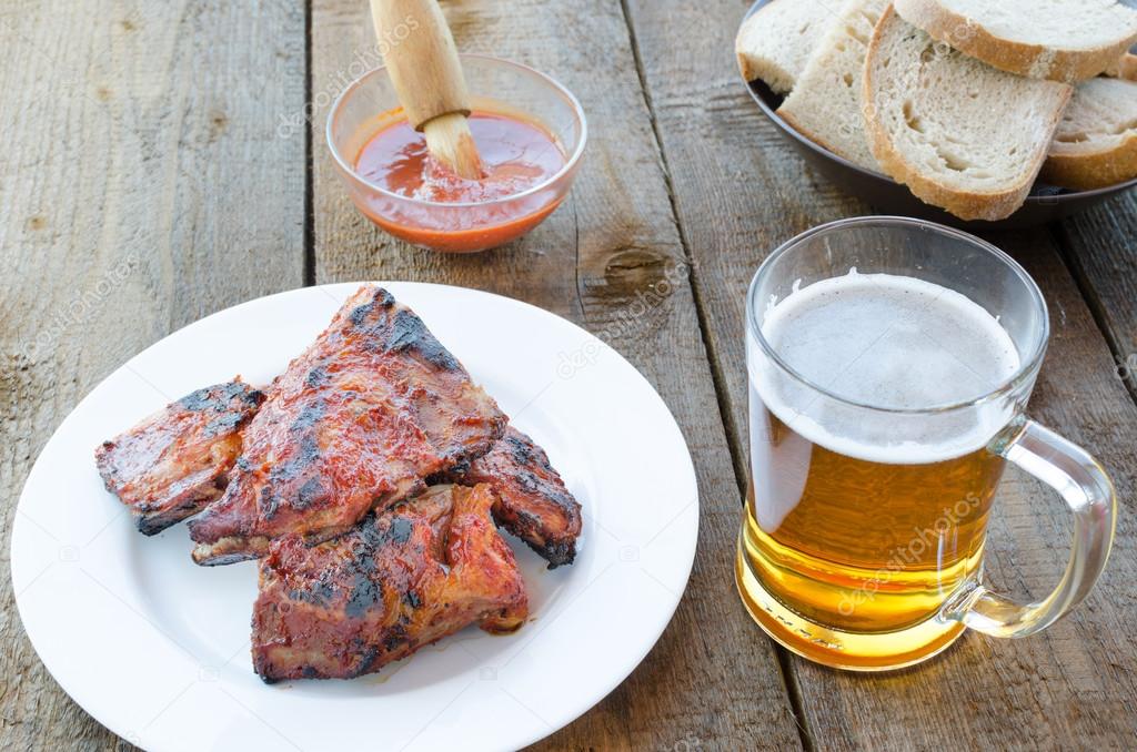 Spareribs on grill with hot marinade, czech beer