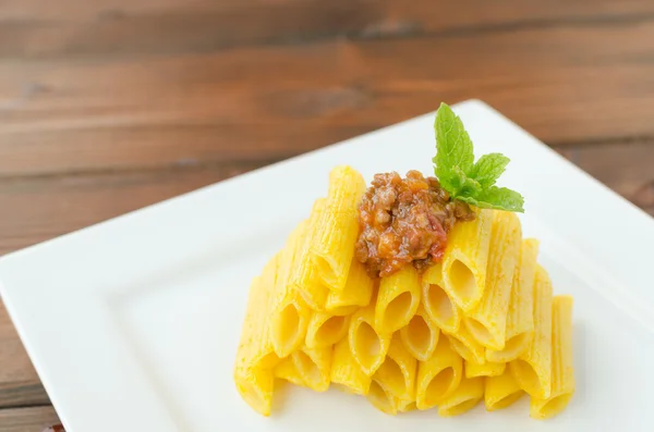 Penne Bolognese on wood table — Stock Photo, Image