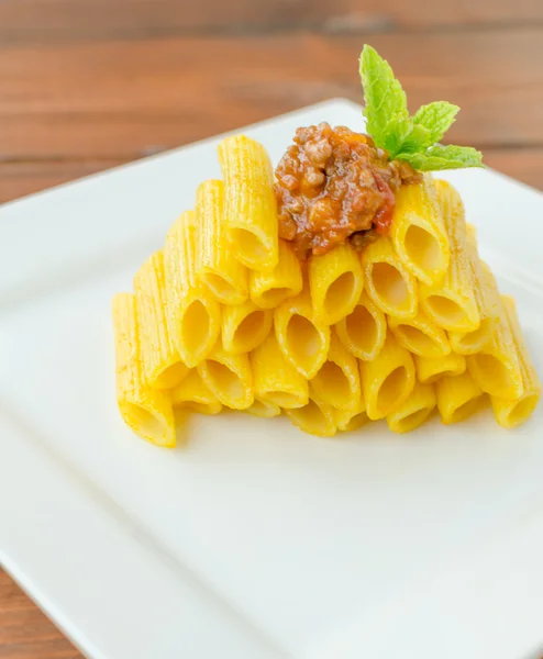 Penne Bolognese on wood table — Stock Photo, Image