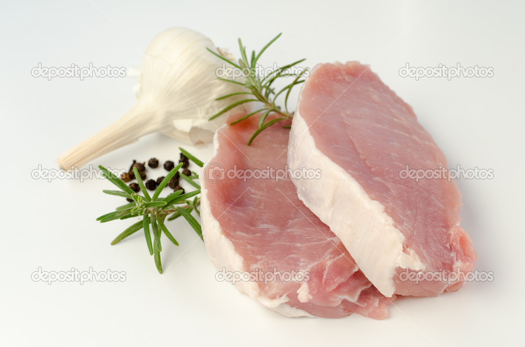 Raw pork chops with rosemary and garlic