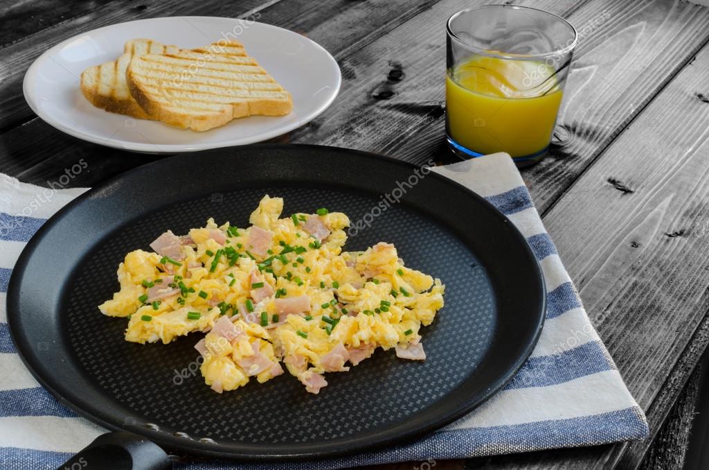 Scrambled eggs on frying pan — Stock Photo © Peteer #50024099
