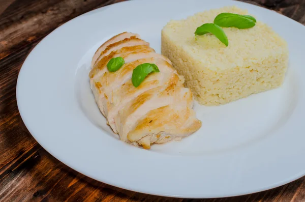 Grilled chicken breast with couscous and basil — Stock Photo, Image