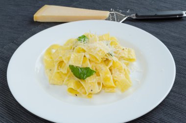 Fresh pappadelle pasta with lemon, basil and creame clipart