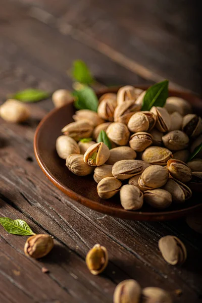 Pistachio nuts product photography on wood board