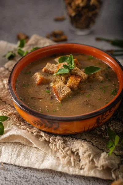 Homemade soup with herbs, crispy pastry and mushrooms