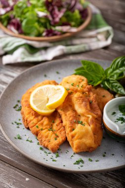 Delicious and simple schnitzel with french fries and garlic sauce