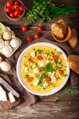 Delicious bio eggs omelette with vegetables and cheese