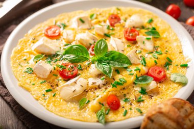 Delicious bio eggs omelette with vegetables and cheese
