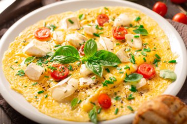 Delicious bio eggs omelette with vegetables and cheese