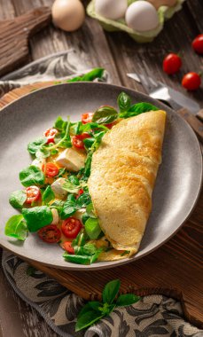 Delicious bio eggs omelette with vegetables and cheese