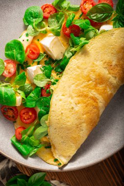 Delicious bio eggs omelette with vegetables and cheese