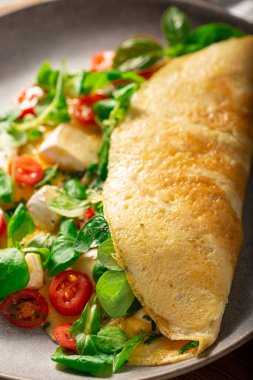 Delicious bio eggs omelette with vegetables and cheese