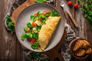 Delicious bio eggs omelette with vegetables and cheese