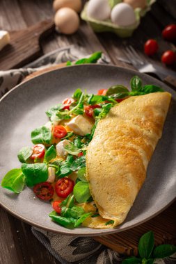 Delicious bio eggs omelette with vegetables and cheese