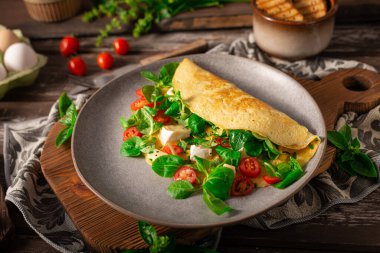 Delicious bio eggs omelette with vegetables and cheese