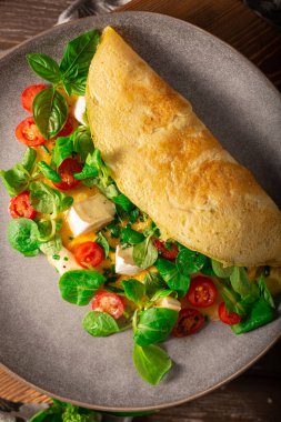 Delicious bio eggs omelette with vegetables and cheese