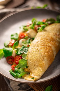 Delicious bio eggs omelette with vegetables and cheese