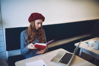 Kafe 'de çalışmak için dizüstü bilgisayar kullanan, günlük giysiler içinde, yoğun kadın serbest çalışan yukarıdan.
