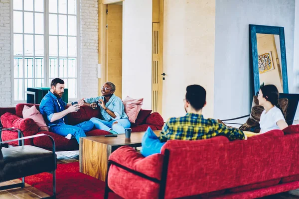 Gündelik giyinen gençler pansiyonda konuşarak boş zamanlarını çatı katının içinde geçiriyorlar. Çeşitli etnik çeşitlilikteki hipsterler evlerinde kahve fincanlarıyla dinleniyorlar.