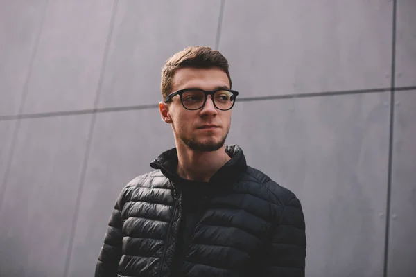 Low Angle Thoughtful Young Man Dark Jacket Eyeglasses Standing Modern — Stock Photo, Image