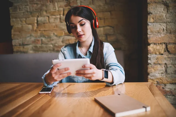 Young Wistful Female Casual Clothes Sitting Wooden Table While Listening — Stock Photo, Image