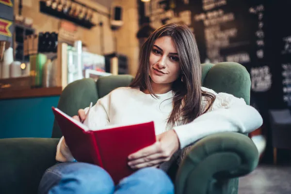 Glad Female Long Hair Looking Camera Sitting Comfortable Armchair Reading — Stock Photo, Image