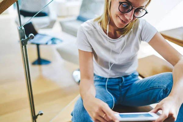 Crop Happy Female Sitting Stairs Earphones Looking Screen Smartphone While — Stock Photo, Image