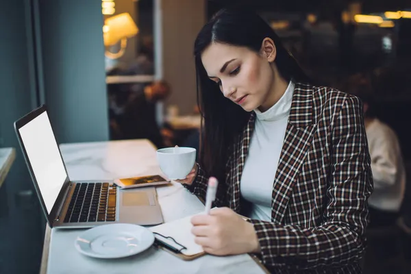 Young Concentrated Female Student Writing Notes Paper Doing Homework Sitting — Stock Photo, Image