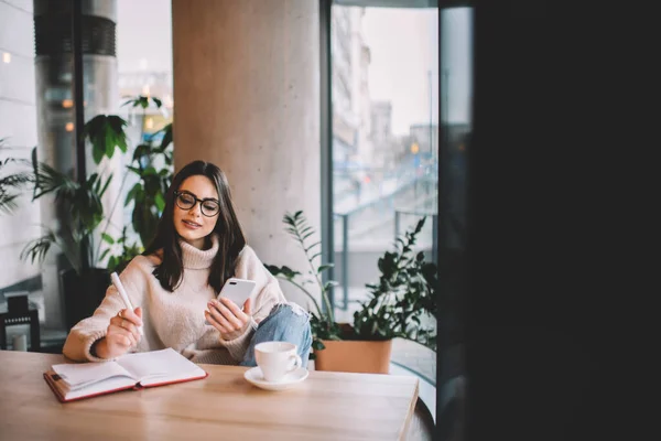 Serious Female Freelancer Casual Wear Eyeglasses Sitting Wooden Table Browsing — Stock Photo, Image