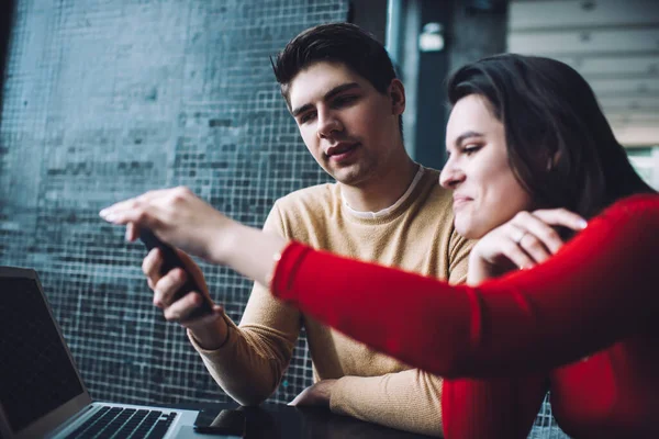 Positive Young Couple Casual Wear Surfing Internet Cellphone While Working — Stock Photo, Image