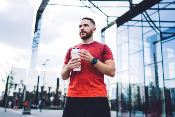 Low Angle Confident Male Runner Sportswear Smartwatch Holding Plastic Bottle — Stock Photo, Image