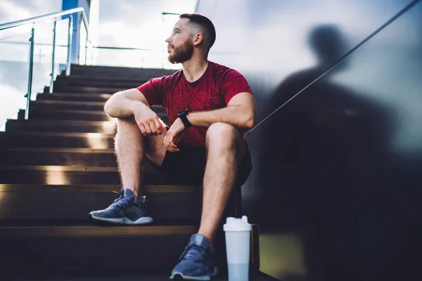 Low Angle Bearded Male Smartwatch Sitting Metal Wall Looking Away — Stock Photo, Image