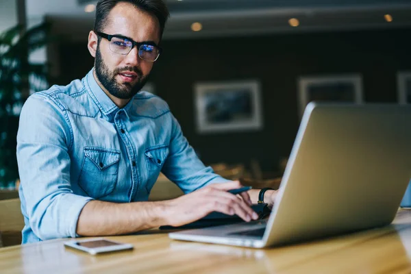 Ernsthafter Bärtiger Arbeiter Jeanshemd Und Brille Der Bei Der Arbeit — Stockfoto