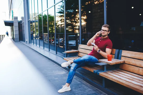 Confident Bearded Guy Wearing Casual Clothes Eyeglasses Sitting Wooden Bench - Stock-foto