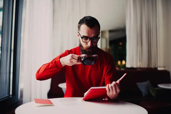 Concentrated Bearded Male Casual Clothes Looking Notebook While Reading Notes — Stockfoto