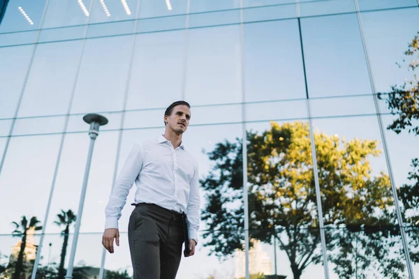 Positive Businessman Carrying Tablet Smiling While Walking Business Center — стоковое фото