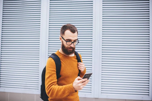 Young Slender Bearded Hipster Yellow Jumper Eyeglasses Black Backpack Reading — Foto Stock