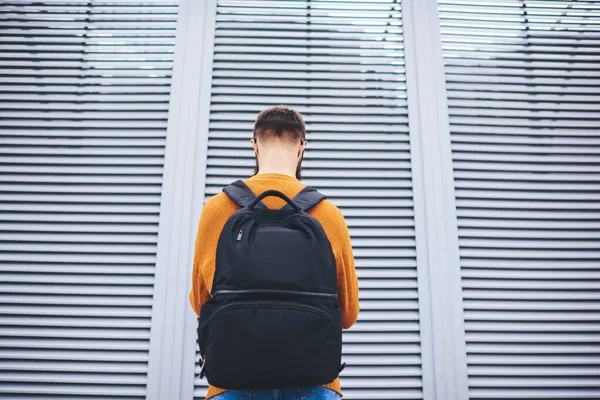 Back View Man Yellow Jumper Black Backpack Standing Front Modern — стоковое фото