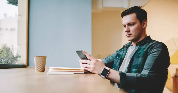 Side View Young Pensive Man Casual Wear Browsing Mobile Phone — Stock Photo, Image