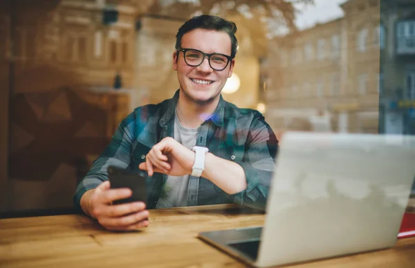 Glass Positive Male Smart Watch Sitting Table Modern Laptop Using — стоковое фото