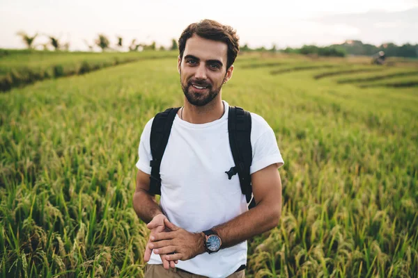 Handsome Young Male Backpacker Casual Shirt Standing Lush Green Field — Stock Photo, Image