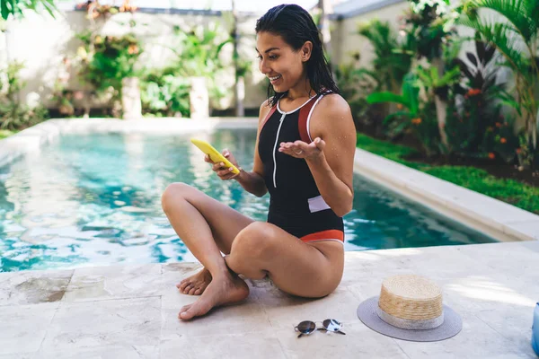 Side View Young Ethnic Female Swimwear Using Smartphone While Sitting — Stockfoto