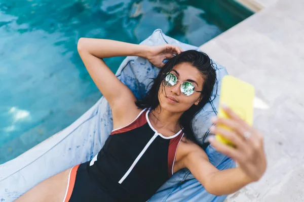 Positive Female Swimsuit Lying Blue Beanbag Lounge Making Self Portrait — Stockfoto