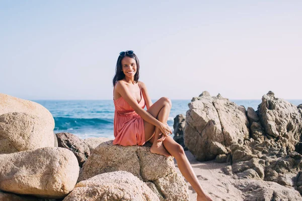 Portrait Cheerful Latin Girl Resting Coastline Stone Smiling Camera Ready — Stockfoto