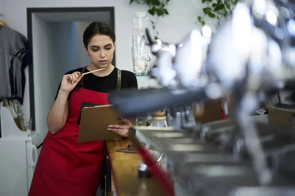 Serious Female Waitress Apron Cafe Uniform Reading Information Report Checking — Fotografia de Stock