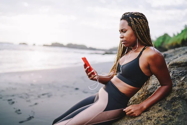 African American Female Athlete Dreads Choosing Music Songs Mobile App — стокове фото