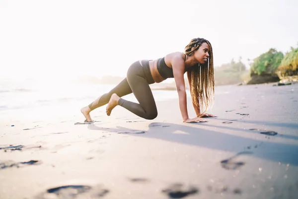 Serious Beautiful Female in Sportswear Doing Exercise Outdoors