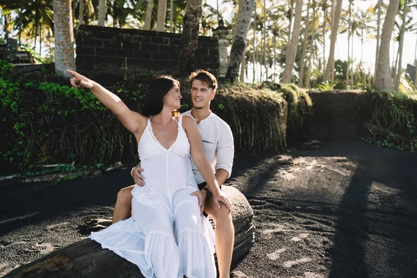 Happy Pregnant Woman White Dress Pointing Sky While Sitting Close — Foto Stock