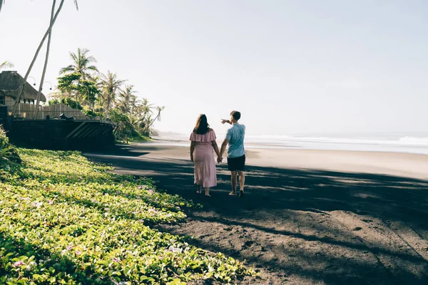 Back View Full Length Man Holding Stylish Girlfriends Hand Pointing — Stockfoto