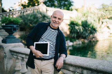 Kafkasyalı mutlu turistlerin yarım boy portresi, seyahat sitesi ve metin reklamları için fotokopi alanı ile dokunmatik ped hazırlıyor, boş dijital tabletle gülümsüyor, boş zamanların tadını çıkarıyor.